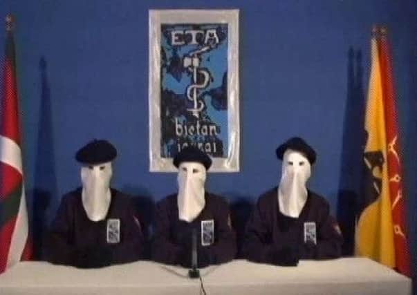 Masked members of the militant Basque separatist group ETA declare a permanent cease-fire in a video the group distributed to Spanish media in January 2011.