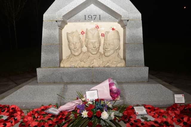 The memorial at Ballysillan Avenue  in March this year, when flowers were left to mark the anniversary of the death of the three Scottish soldiers.