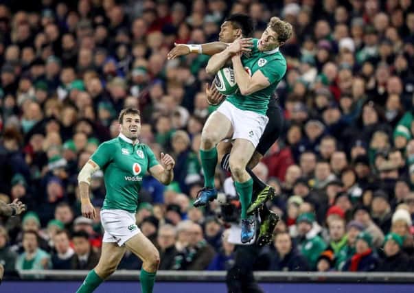 Ireland's Andrew Trimble and New Zealand's Julian Savea contest the ball