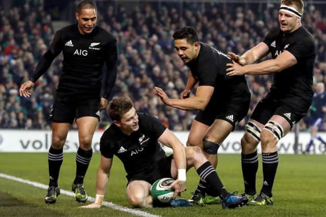 New Zealand celebrate with Beauden Barrett as he scores a try