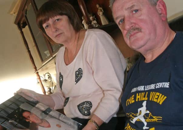 Liz and Martin Gallagher, pictured with a photo of their son, Martin, who was killed in a hit and run accident on the Racecourse Road at Hallowe'en last year. 1911JM18