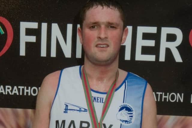 Martin Gallagher, pictured after completing the London Marathon.