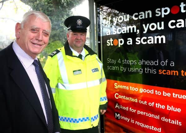 Causeway Coast and Glens Policing and Community Safety Partnership Chairman, Alderman William King and Sergeant Terry McKenna, show their support for the ScamwiseNI campaign. Picture: Kevin McAuley/Multimedia