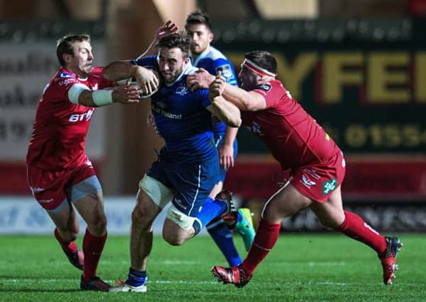 Leinster's Jack Conan evades the tackle of Scarlets' Hadleigh Parkes