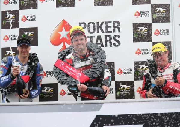 Hawk Racing BMW's Michael Dunlop celebrates winning the Pokerstars Senior TT at the 2016 Isle of Man TT with runner up Ian Hutchinson (Tyco BMW ) and third placed John McGuinness (Honda).