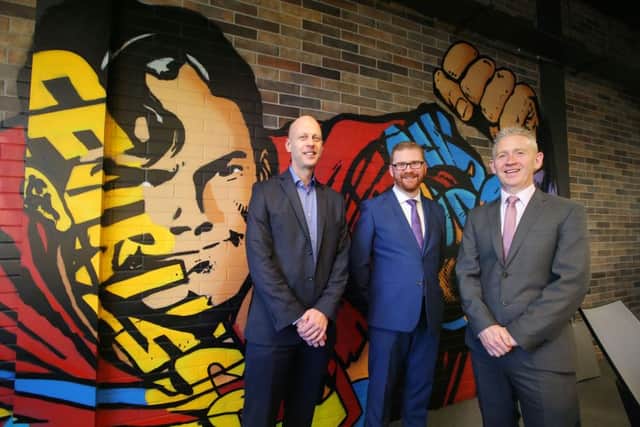 Economy Minister Simon Hamilton pictured at the official opening of Belfast IT leader Novoscos new offices with managing director Patrick McAliskey, right, and sales director John Lennon