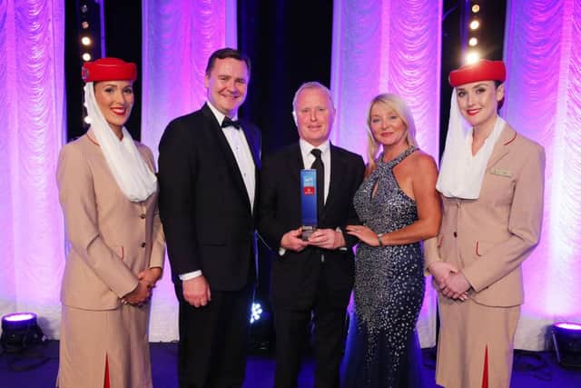 Hotelier Bill Wolsey, centre, receives his UTV Business Eye Personality of the Year award from Enda Corneille, country manager, Emirates in Ireland, and Brenda Buckley from Business Eye