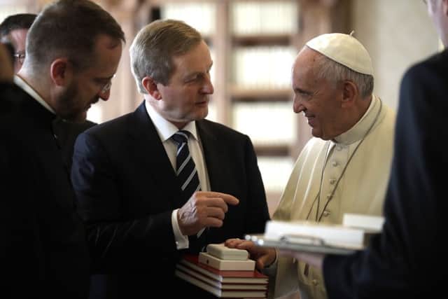 Pope Francis  exchanges gifts with Irish Prime Minister Enda Kenny during a private audience in his private studio at the Vatican, Monday, Nov 28, 2016. (AP Photo/Alessandra Tarantino, pool )
