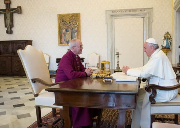 Modern popes, such as Pope Francis, seen above meeting the Archbishop of Canterbury Justin Welby in 2014, are not like popes of the 1800s (AP Photo/L'Osservatore Romano)