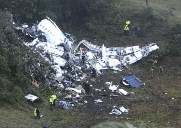CORRECTS DATE - Police officers and rescue workers search for survivors around the wreckage of a chartered airplane that crashed in La Union, a mountainous area outside Medellin, Colombia, Tuesday, Nov. 29, 2016. The plane was carrying the Brazilian first division soccer club Chapecoense team that was on it's way for a Copa Sudamericana final match against Colombia's Atletico Nacional. (AP Photo/Luis Benavides)