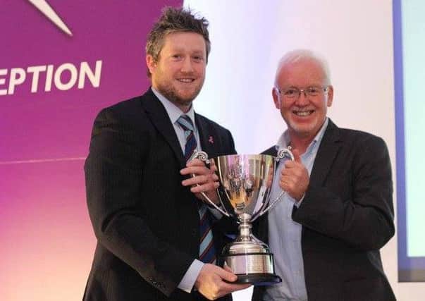 CSNI captain Andrew Cowden (left) collects the NICSSA Club of the Year award.