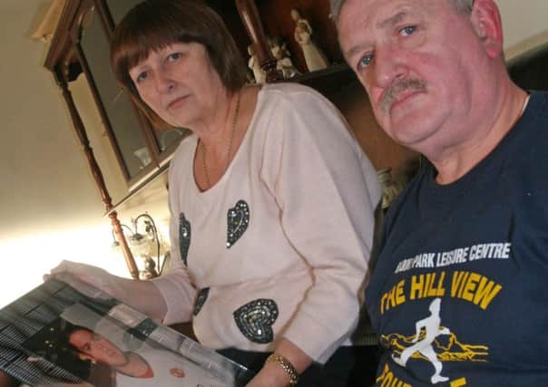 Liz and Martin Gallagher, pictured with a photo of their son, Martin, who was killed in a hit and run incident in Londonderry.