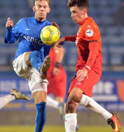 .
Glenavon's Mark Sykes
and Swifts' Seanan Clucas
during Friday night's match at Mourneview Park.
 (Photo by TONY HENDRON/Presseye.com.)