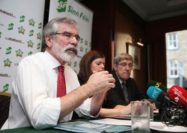 Sinn Fein leader Gerry Adams (left) during a Sinn Fein press conference at the Davenport Hotel in Dublin that was interrupted by Austin Stack. The party is trying to make amends for members of the Irish security forces that it killed, while pressing ahead with convincing people that northern killings were justified. Photo: Brian Lawless/PA Wire