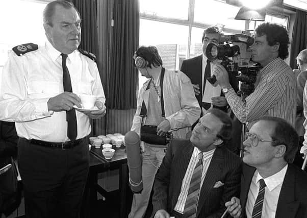 A young Austin Hunter (front right) working as a journalist  at an RUC press conference
 in 1988, with the then RUC chief constable Sir John Hermon, left