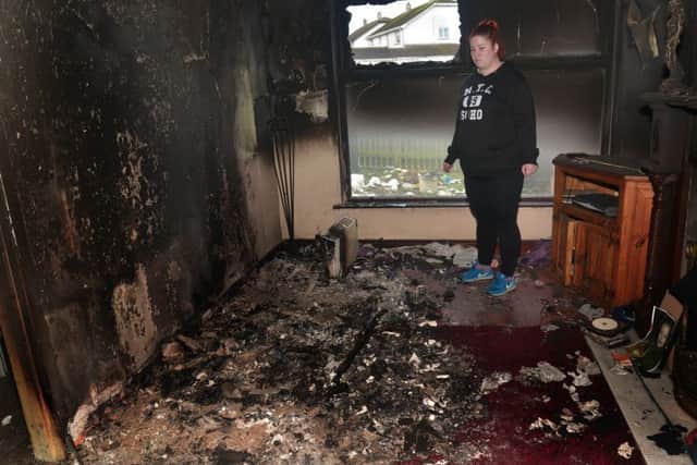 Sarah Harper in her fire damaged living room. INLM50-202.