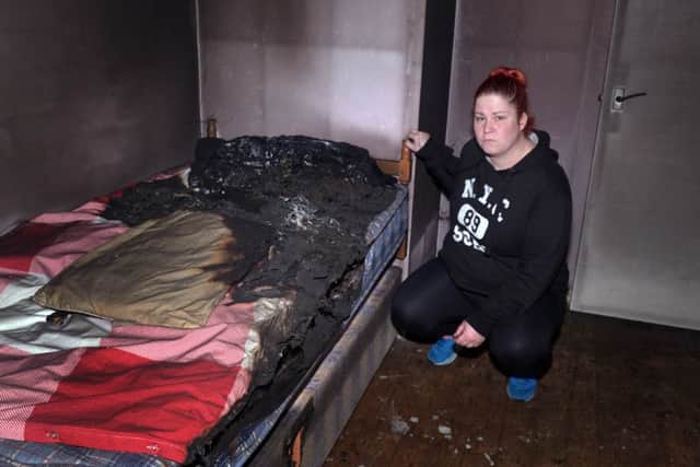 Sarah Harper in one of her fire damaged bedrooms. INLM50-205.
