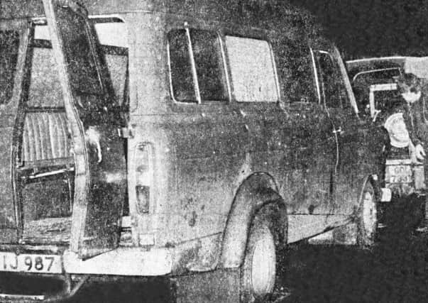 The bullet-riddled minibus in which the murdered men were travelling stands at the side of the lonely country road where the massacre occurred in 1976