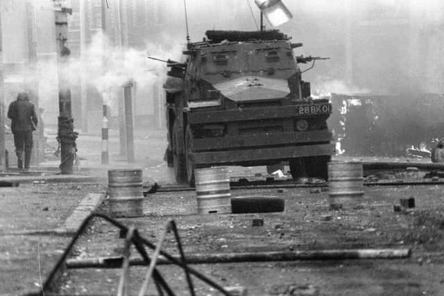 A British Army armoured vehicle makes its way along a barricade while on patrol in the Lower Falls area of west Belfast on April 17 1972. Trouble in the area erupted after the shooting of Joe McCann, an IRA leader, the previous day. (AP Photo/Michel Lipchitz, File)