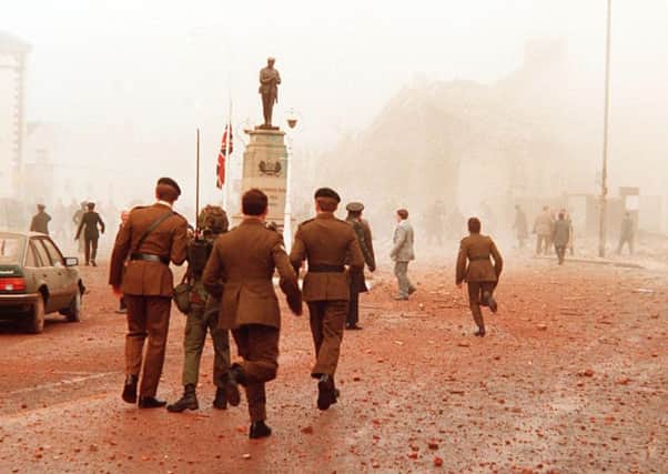 People run to help casualties after the IRA bomb on Remembrance Day in Enniskillen in 1987. Pic: Pacemaker