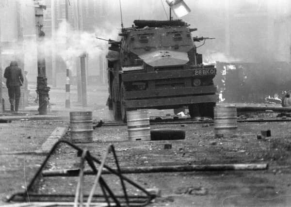 April 17, 1972, a British Army armoured vehicle makes its way along a barricade while on patrol in the Lower Falls area of west Belfast. AP Photo/Michel Lipchitz