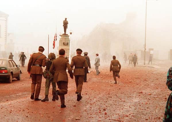The aftermath of the 1987 
Enniskillen Poppy Day massacre. Soldiers run to aid the dying and wounded after the 1987 IRA bomb attack. Pic: Pacemaker.