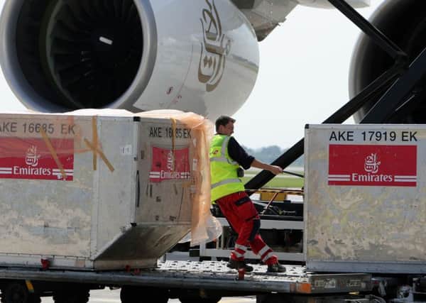 A member of Swissport staff removing boxes from an Airbus A380