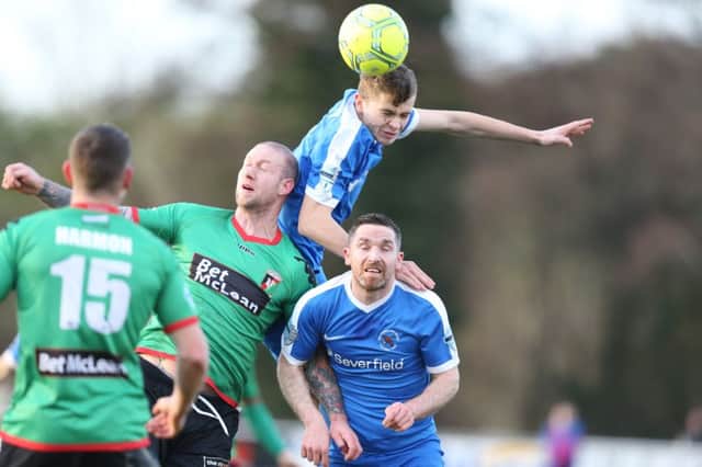 Ross Taheny and Jason McCartney of Ballinamallard with Stephen O'Flynn Picture by Andrew Paton/Press Eye
