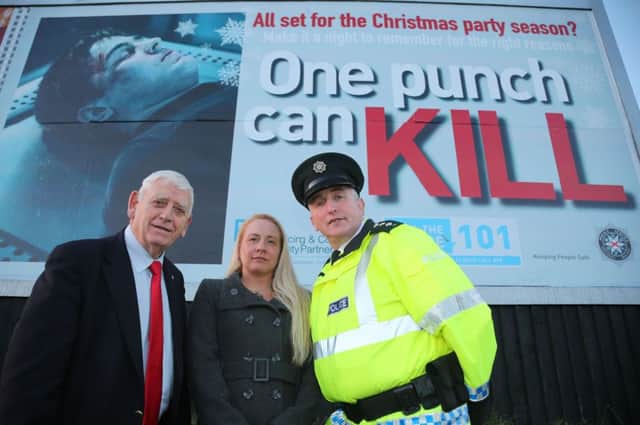 Pictured are Causeway Coast and Glens Policing and Community Safety Partnership chairperson, Alderman William King, PCSP officer Melissa Lemon and PSNI chief inspector Ian Magee at a billboard promoting the One Punch campaign at the Metropole in Portrush