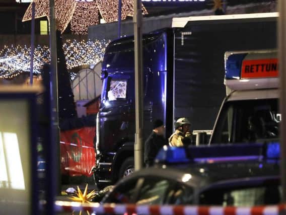 Police stand beside the damaged truck in Berlin
