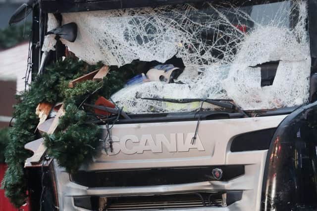 The smashed window of the cabin of a truck which ran into a crowded Christmas market in Berlin