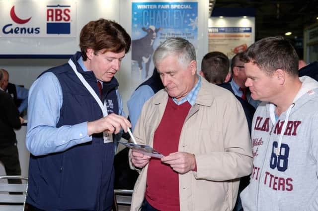 Kyle Henry, Genus ABS chats to Tommy and Sam Newell, Kilkeel on the Genus ABS stand at the RUAS Winter Fair. Photograph: Columba O'Hare