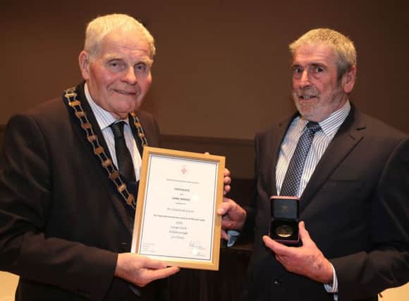 AFBIs Desmond Irwin accepts his Long Service Award from Billy Robson