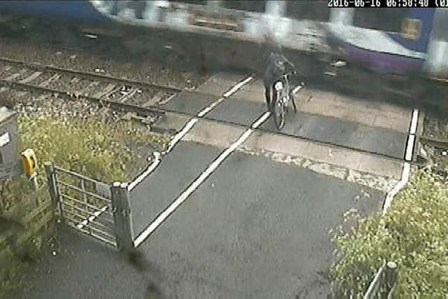 WATCH: Dramatic footage shows cyclist in near-miss with train at level ...