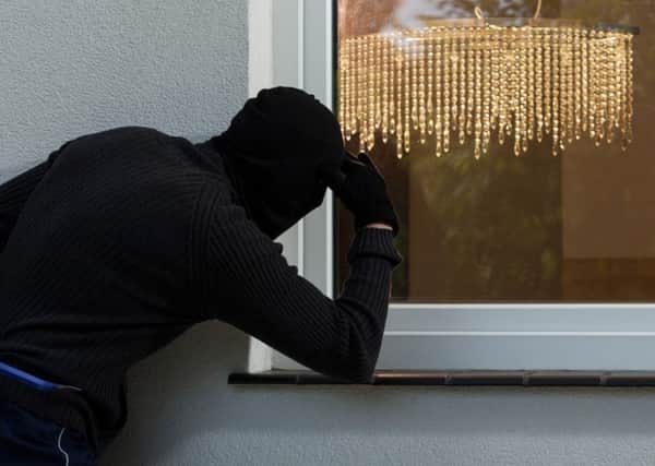 A Generic Photo of a burglar attempting to break into a property through a window.  PA Photo/thinkstockphotos