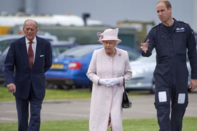 Queen Elizabeth II and the Duke of Edinburgh with their grandson, the Duke of Cambridge