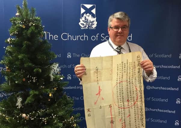 Church of Scotland's of Sandy Sneddon, Asia secretary of the Church of Scotland's World Mission Council holding a fragile handwritten public proclamation which has cast fresh light on the impact of a bloody rebellion on Scottish Presbyterians in China more than 100 years ago
