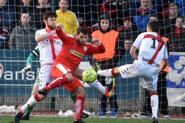 Cliftonville's David McDaid  in action with Crusaders Howard Beverland. 
Photograph by Stephen Hamilton/Presseye