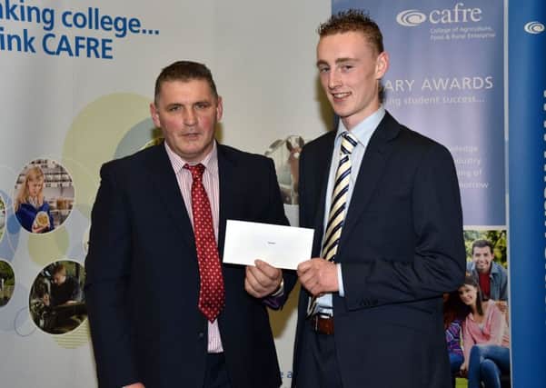 David Woods presents the Genus ABS bursary cheque for Â£1k to James Toner, Markethill, Co Armagh.