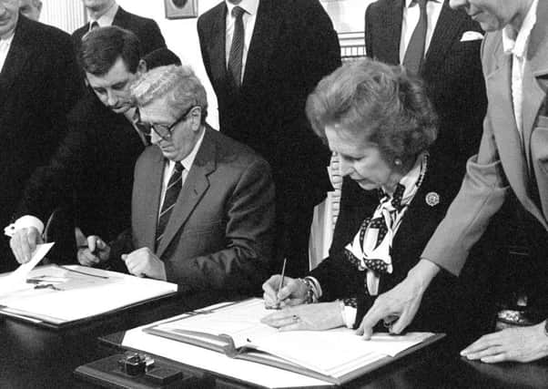 Margaret Thatcher and Garret FitzGerald sign the Anglo-Irish Agreement at Hillsborough Castle in 1985