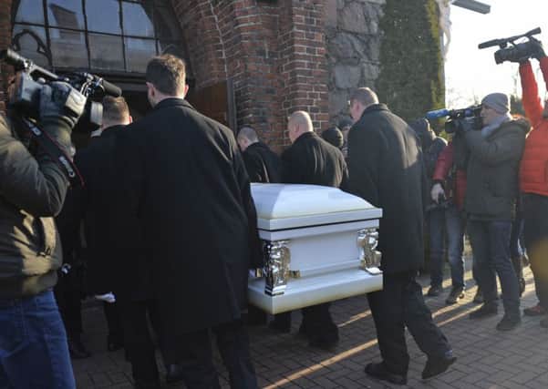 The coffin with the body of Lukasz Urban, the Polish truck driver killed in the Berlin Christmas market attack, is carried into the church in Banie, Poland, Friday, Dec. 30, 2016, ahead of the funeral ceremonies. (AP Photo/Lukasz Szelemej)