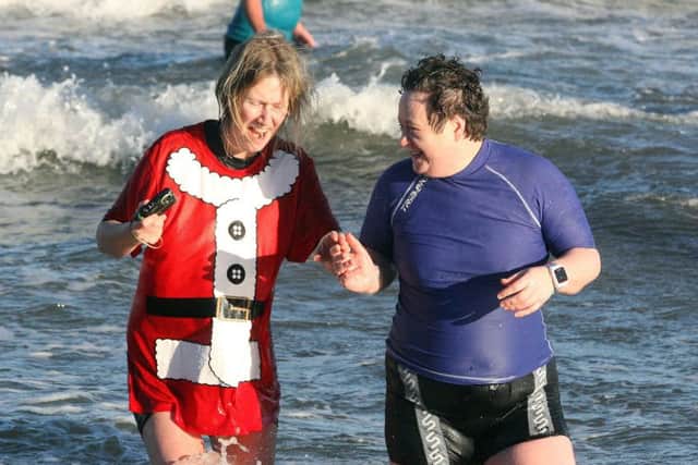 Shaking off the excess of Christmas and making a fresh start to the New Year by taking a chilly dip at Crawfordsburn Beach. Picture by Freddie Parkinson/Press Eye