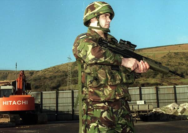A British soldier stands guard for the last time at Fort Whiterock Army base in west Belfast in January 1999 as bulldozers move in to dismantle the remains of the 20-year-old base. In 2007 the Troubles-related Operation Banner was declared over
