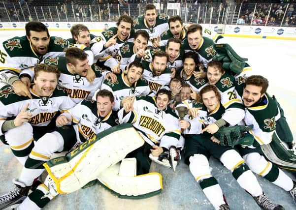 Vermont Catamounts celebrate winning the Friendship Four Final and lifting the Belpot Trophy