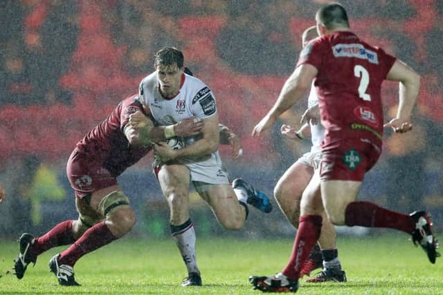 Andrew Trimble of Ulster is tackled by Tom Price of Scarlets.