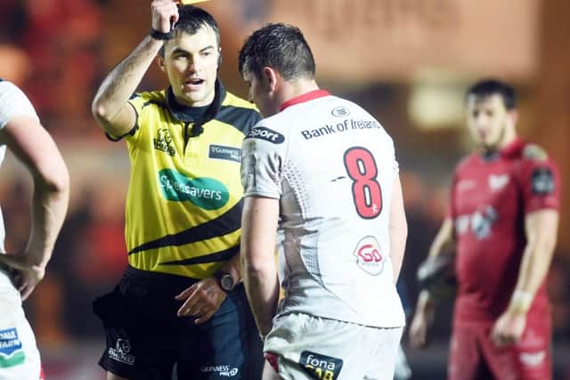 Referee Marius Mitrea shows Sean Reidy of Ulster a yellow card before awarding Scarlets a controversial penalty try