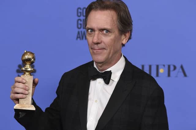 Hugh Laurie poses in the press room with the award for best performance by an actor in a supporting role in a series