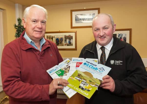 Lexie Scott, Chairman of Broughshane and District Community Association, and PSCP member Councillor Reuben Glover at the launch of the Oil Club calendar in Broughshane House.
