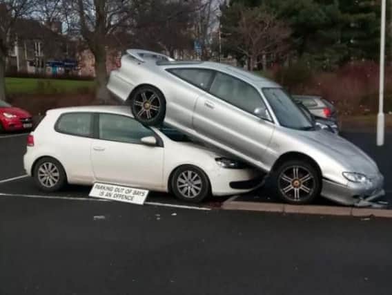 Parking attendants found a Mazda parked on top of a Volkswagen Golf.