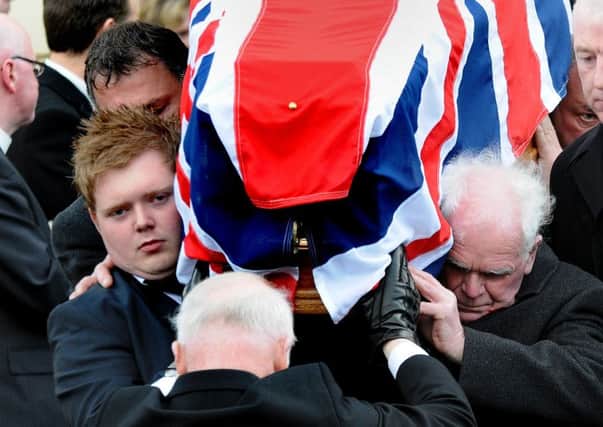 Shoulder to shoulder, Kyle Black and his grandfather Edmund as they carry the coffin of David Black